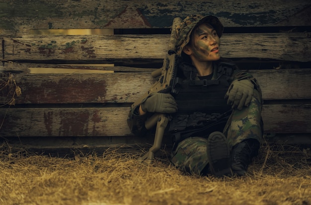 army-girl-with-rifle-sitting-forest-battlefield-area_67123-345.jpg